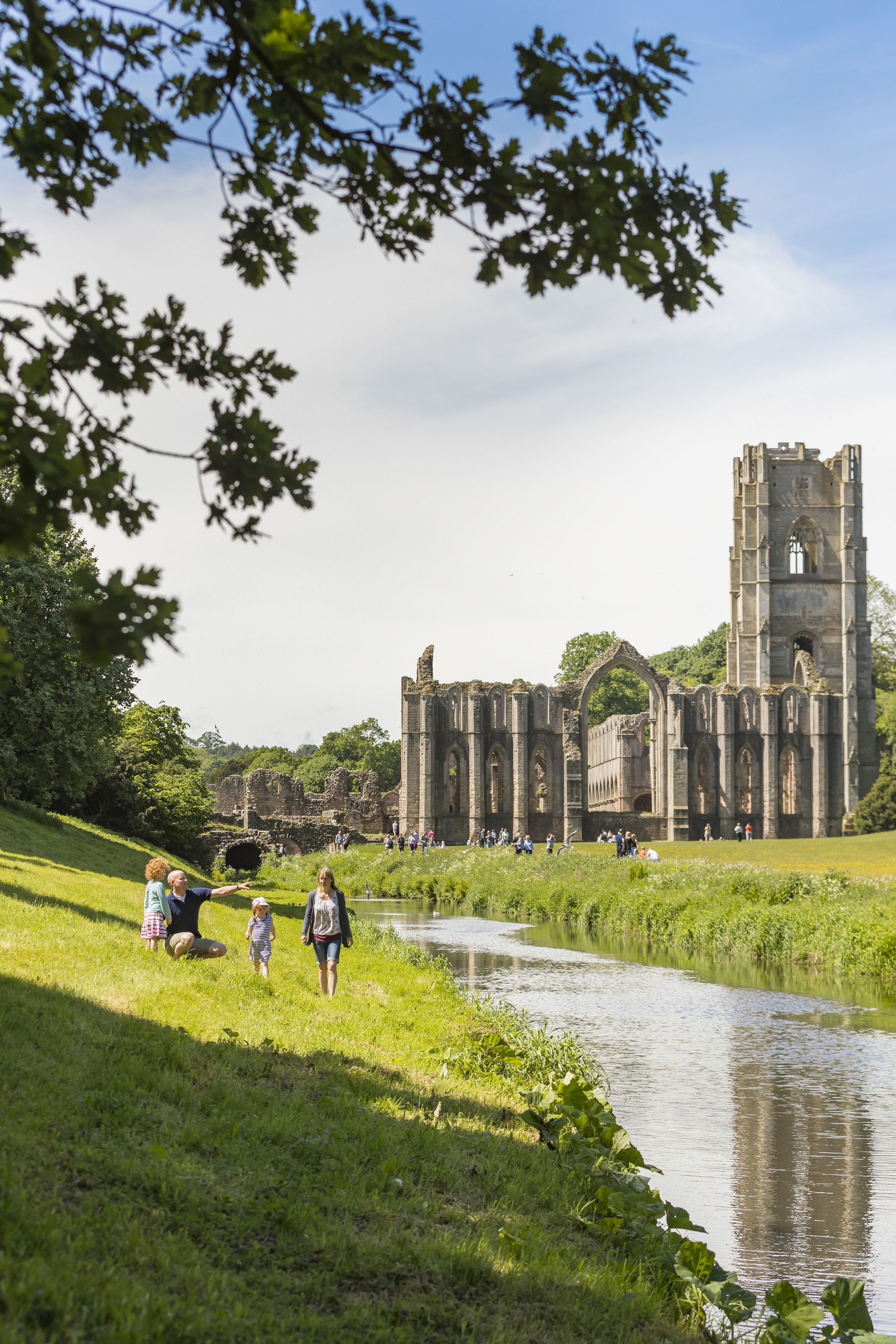 Visitors walking through the grounds of Fountains Abbey and Studley Royal Water Garden, North Yorkshire